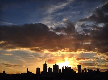High section of silhouette building against sky at sunset