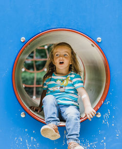 Girl looking away while playing in playground