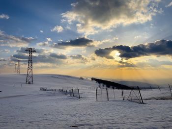 Beautiful sunset over transmission towers in winter