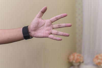 Close-up of person hand with tattoo against blurred background