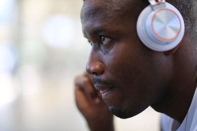 Close-up portrait of young man looking away