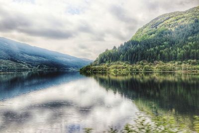 Scenic view of lake and mountains against sky