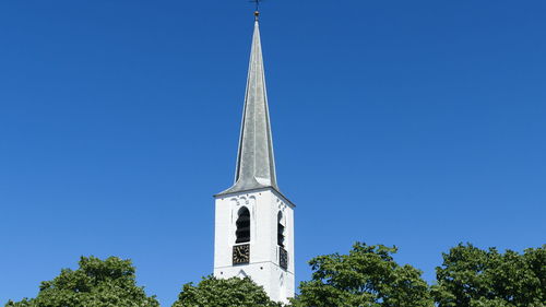 Low angle view of building against clear blue sky