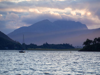 Scenic view of river against cloudy sky