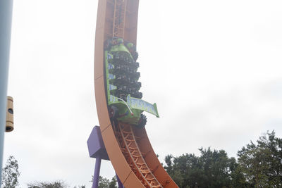 Low angle view of amusement park ride against sky