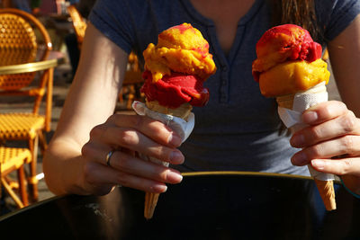 Midsection of woman holding ice creams