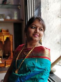 Smiling young woman wearing sari while looking away