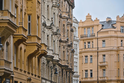 Low angle view of buildings in town against sky