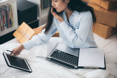 Midsection of woman using laptop on table