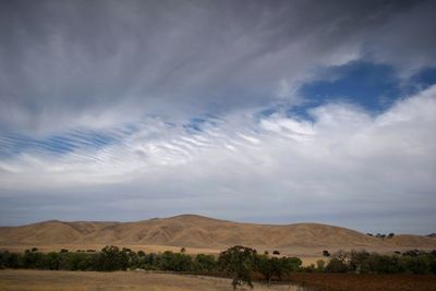 Scenic view of desert against blue sky