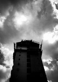 Low angle view of building against cloudy sky