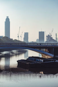 Buildings in city against clear sky