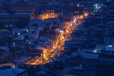 High angle view of illuminated buildings in city at night