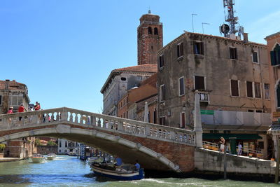 View of bridge over river in city