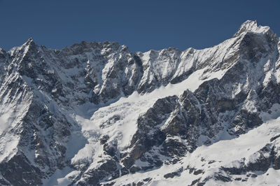 Scenic view of snowcapped mountains against clear sky