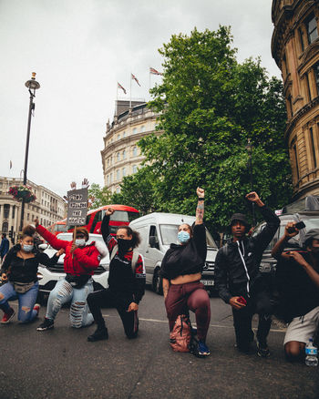 GROUP OF PEOPLE IN FRONT OF BUILDINGS