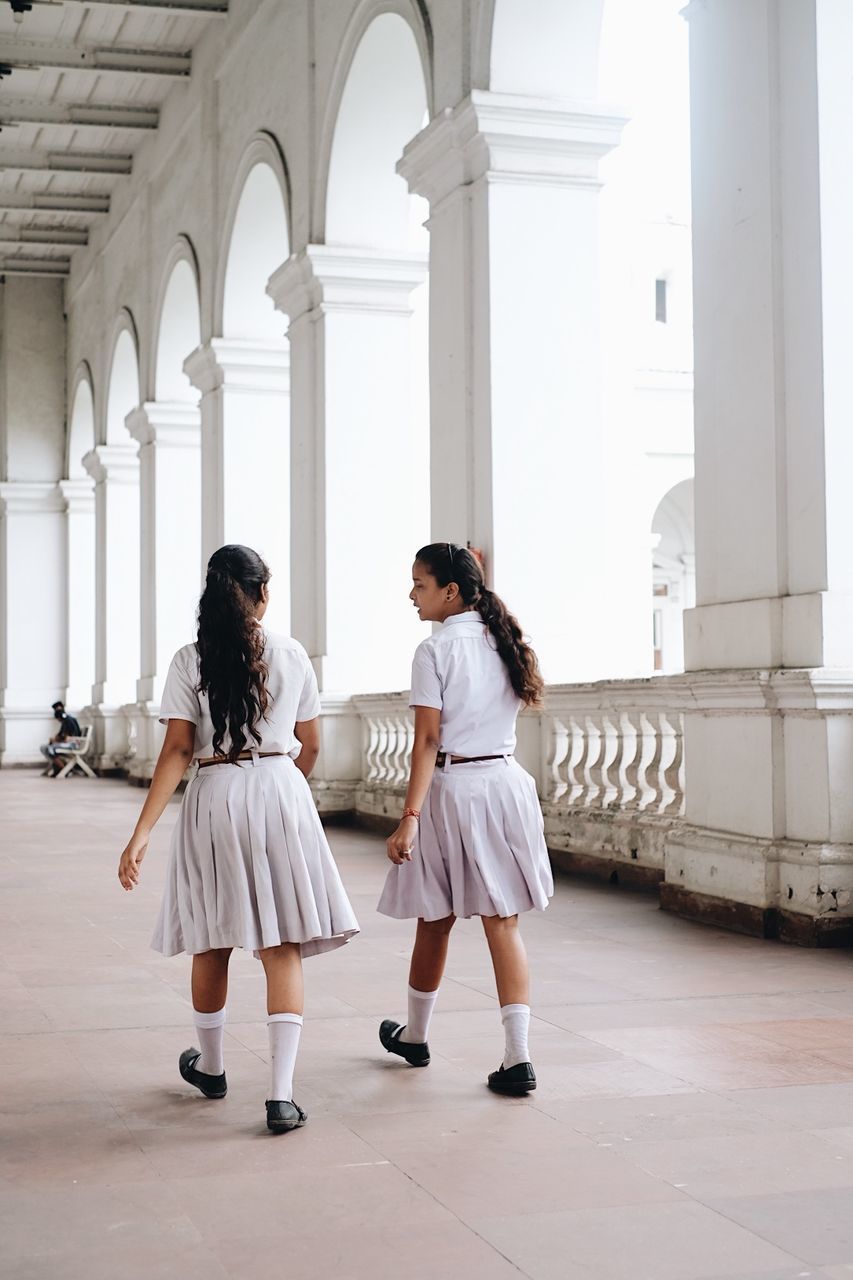 WOMEN STANDING IN BUILDING