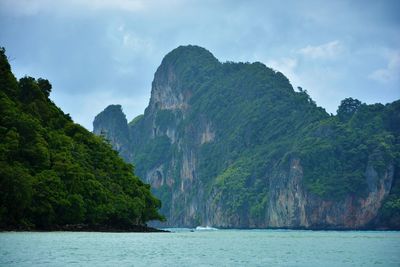 Scenic view of sea and mountains against sky