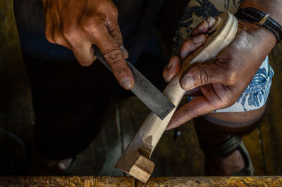 Violin maker luthier hand working a new violin scroll in cremona italy