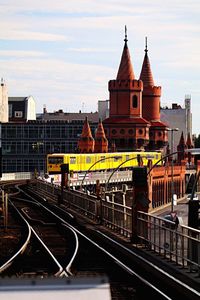 Yellow train on oberbaumbruecke bridge against sky