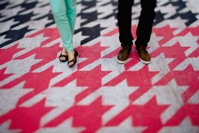 Low section of man and woman standing on floor