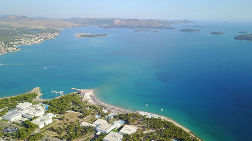 High angle view of sea and cityscape against sky