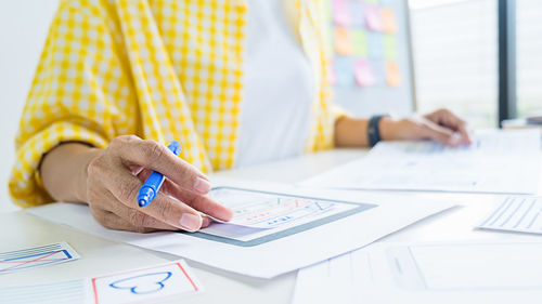 Midsection of businesswoman working in office