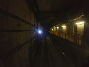 Train in illuminated tunnel at night