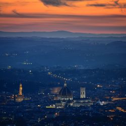 High angle view of illuminated cityscape against sky during sunset