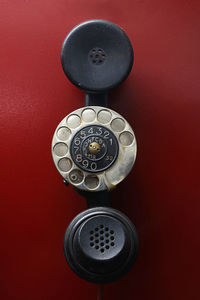 Vintage telephone against red background