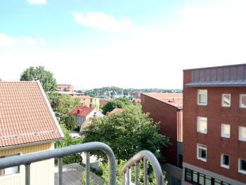 Trees and houses against sky