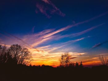 Low angle view of silhouette trees against sky at sunset