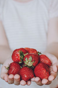 Close-up of hand holding strawberries