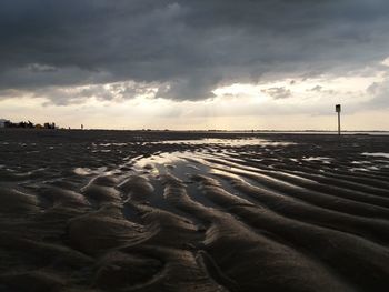 Scenic view of beach against sky during sunset