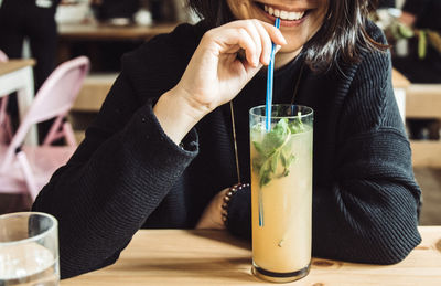 Close-up of woman drinking cocktail