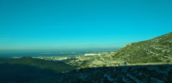 Scenic view of mountains against clear blue sky