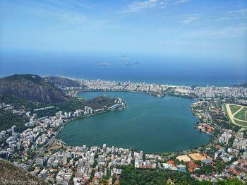 High angle view of cityscape by sea against sky