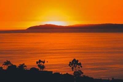 Scenic view of sea against orange sky