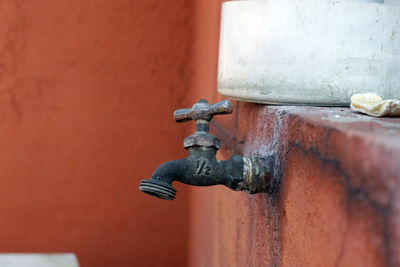 Close-up of old rusty pipe against wall