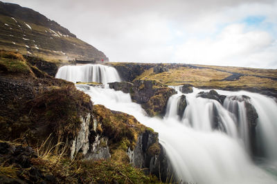 Scenic view of waterfall against sky long exposure