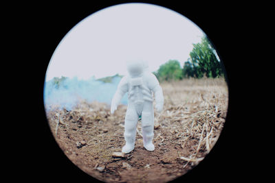 Rear view of a man walking on field