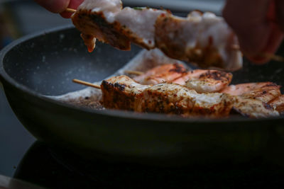 Close-up of hand holding pizza