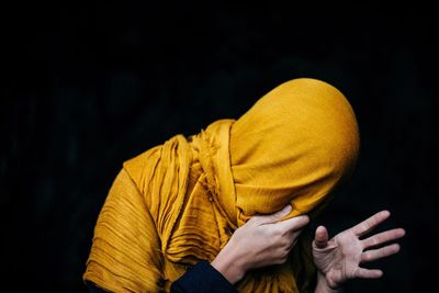 Close-up of human hand against black background