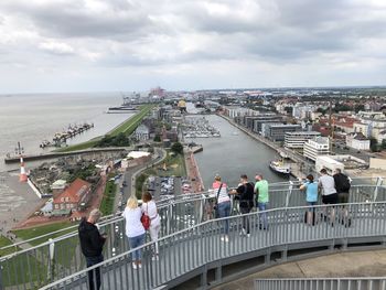 High angle view of people on bridge in city against sky