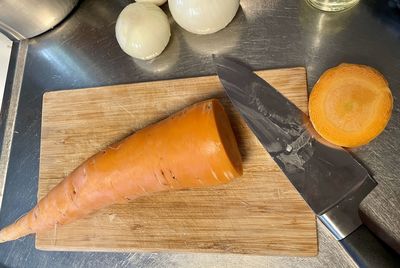 High angle view of carrot and knife on cutting board