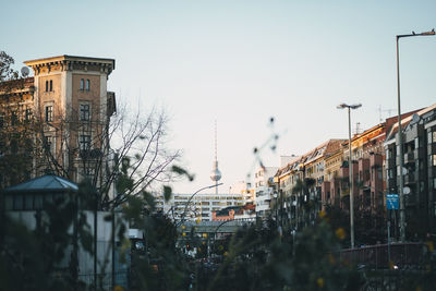 Buildings in city against clear sky