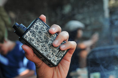 Close-up of person holding camera