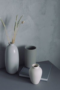 Flower vase on table against wall at home