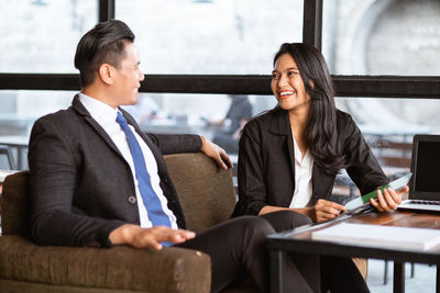 Portrait of businesswoman using laptop at office