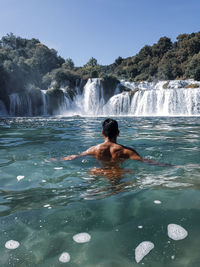 Full length of shirtless man in sea